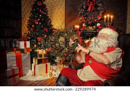 Santa Claus sitting at home with gifts, dressed in his home clothes. Christmas. Decoration.