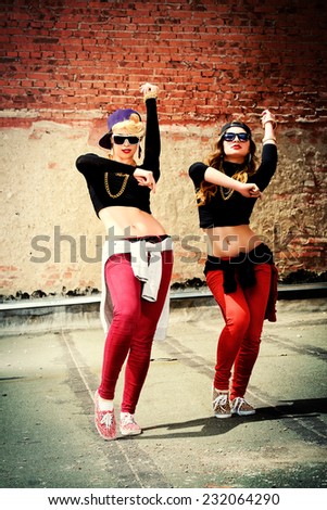 Modern hip-hop dancers over brick wall. Urban lifestyle.
