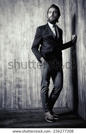 Black-and-white portrait of a respectable handsome man in a suit. Men\'s fashion.