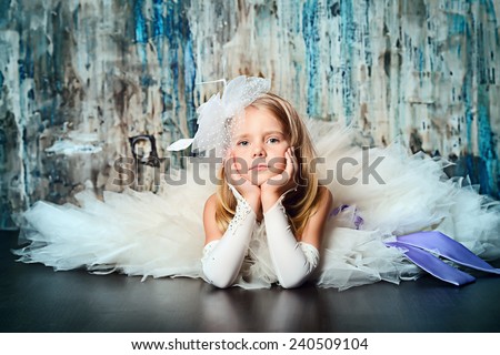 Art portrait of a pretty little girl wearing princess dress. Fashion shot. Childhood.