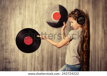 Cute happy teen girl enjoys the music in headphones. Generation. Studio shot.