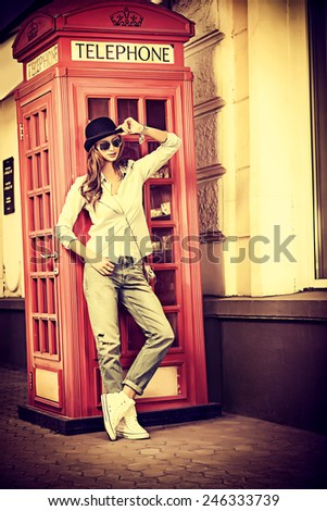 Beautiful young woman walking in the city. Europe, England. Vacation, tourist trip. Vintage style.