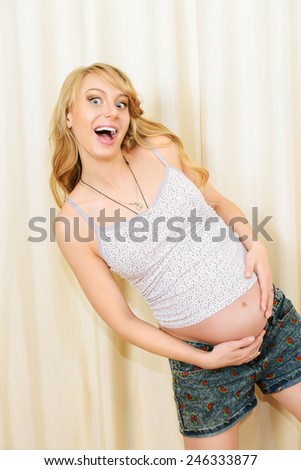 Portrait of a lively pregnant woman. Onset of labor. Healthcare. Family concept.