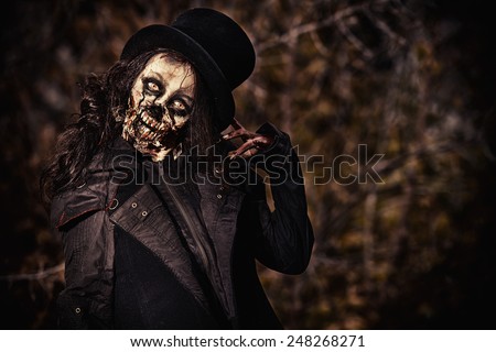 Scary zombie girl standing outdoor. Sugar skull. Halloween.