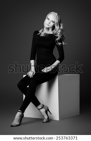 Art portrait of a beautiful slim young woman in black fitting clothing. Beauty, fashion. Body care.