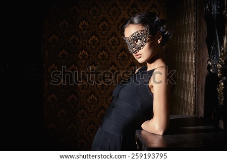 Beautiful mysterious stranger girl in venetian mask. Carnival, masquerade. Jewellery, gems.