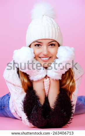 Joyful girl in warm knitted clothing smiling at camera. Beauty, fashion. Winter lifestyle.