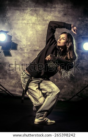 Modern hip-hop dancer over grunge background.