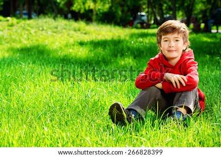 Cute 7 years old boy having fun outdoor. Summer day.