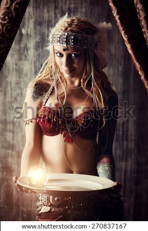 Magnificent fortune teller holding crystal ball. Divination. Magic. Halloween.