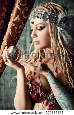 Magnificent fortune teller holding crystal ball. Divination. Magic. Halloween.