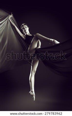 Black-and-white portrait of a graceful beautiful ballet dancer posing at studio. Art concept.