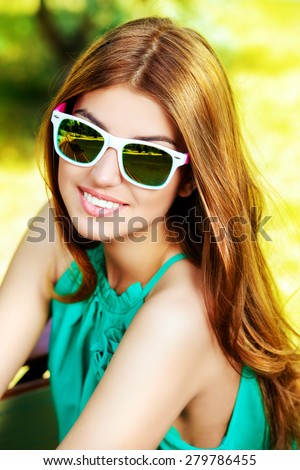 Happy young woman with beautiful smile outdoors. Summer day.