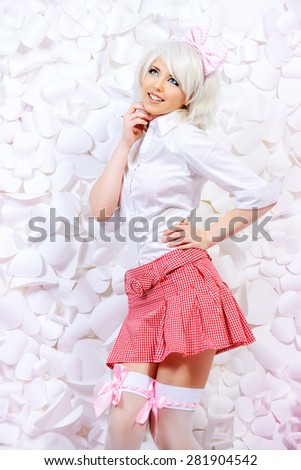 Lovely girl wearing white wig and white blouse with plaid skirt posing over  background of white paper flowers. Anime style.
