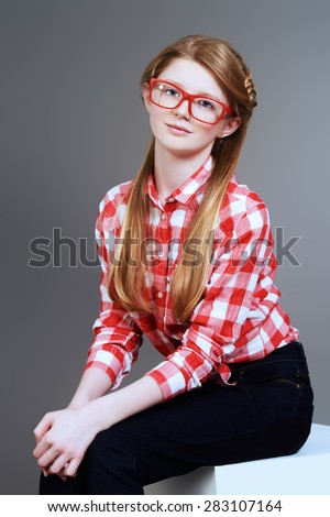 Cute smiling teen girl posing at studio. Youth style. Education.