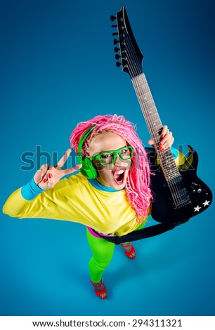 Female rock star playing the electric guitar. Bright style. Show business.