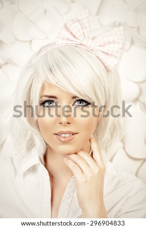 Close-up portrait of a lovely girl wearing white wig and white blouse posing over  background with paper flowers. Anime style.