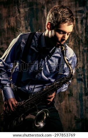 Young expressive musician playing the saxophone. Art and music. Jazz music.