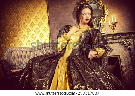 Renaissance Style -  beautiful young woman in the lush expensive dress in an old palace interior. Vintage style. Fashion.
