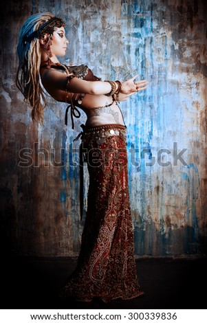 Art portrait of a beautiful traditional female dancer. Ethnic dance. Belly dancing. Tribal dancing.