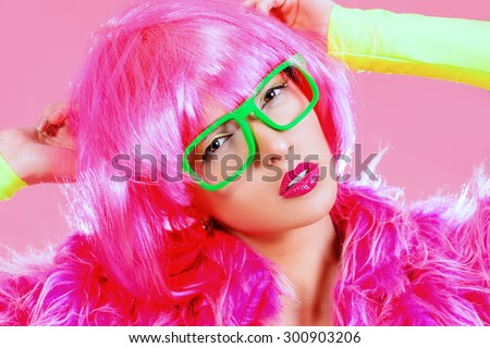 Charming fashion model alluring in sexy colourful clothes. Bright fashion. Pin-up, pink style. Optics, eyewear. Studio shot.