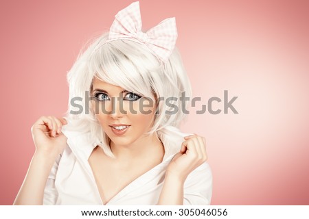 Close-up portrait of a lovely girl wearing white wig and white blouse posing over pink background. Anime style.