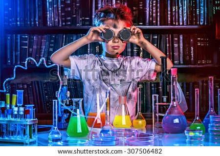 A boy doing experiments in the laboratory. Explosion in the laboratory. Science and education.