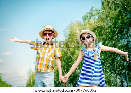 Portrait of happy kids on a bright sunny day. Friendship. Summer holidays.