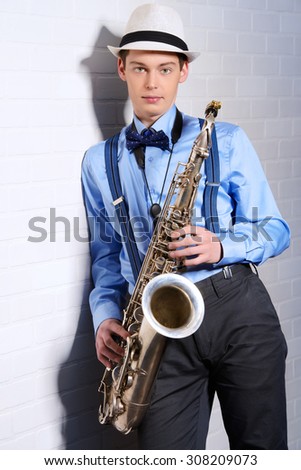 Portrait of a musician with his saxophone. Art and music. Jazz music.