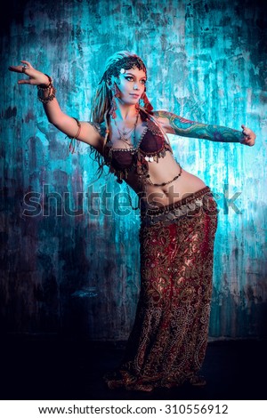 Art portrait of a beautiful traditional female dancer. Ethnic dance. Belly dancing. Tribal dancing.