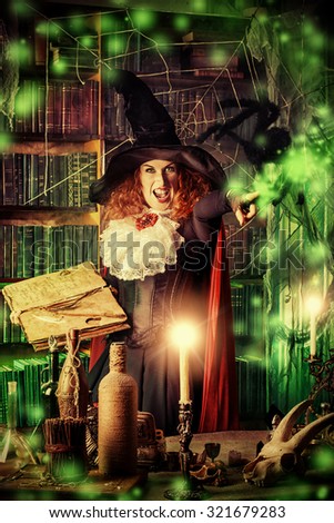 Attractive witch in the wizarding lair. Fairytales. Halloween.