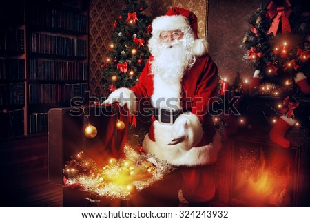 Old Santa Claus with Christmas gifts at home. Christmas decoration.