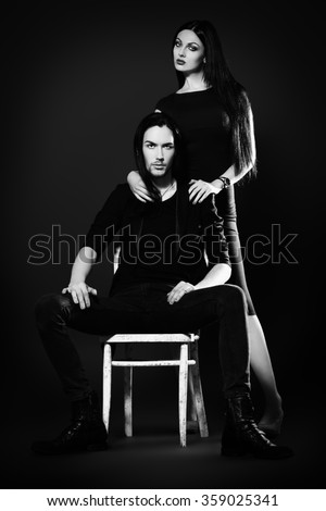Fashion shot of a beautiful sexual couple in black clothes. Fashion, glamour. Black background.
