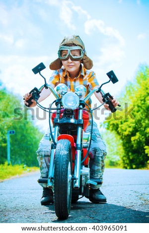 Handsome boy go on a journey on a motorcycle. Adventure. Summer holidays. Active lifestyle.