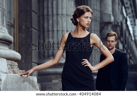 Fashion style photo of a beautiful couple over city background.