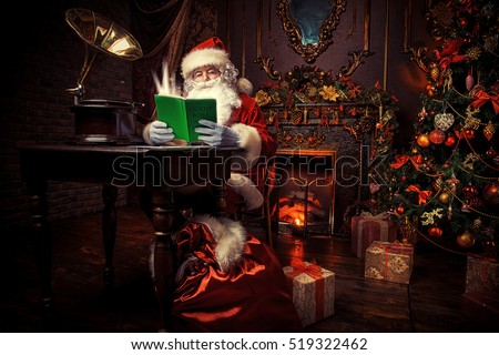 Good old Santa Claus in his house next to the fireplace and Christmas tree ready for Christmas.