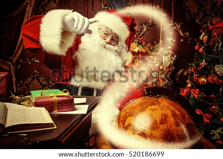 Santa Claus at home reading the post and plans to travel around the planet. Christmas time. Time for miracles.