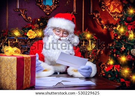 Santa Claus is preparing for Christmas, he is reading children\'s letters. Mail of Santa Claus. Christmas decoration.