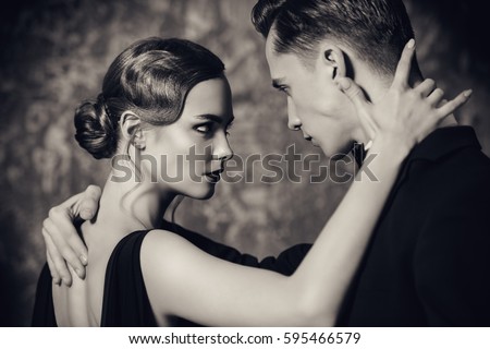 Beautiful passionate dancers dancing tango. Professional dancers. Couple in love dancing on a date. Love concept. Retro style, sepia.
