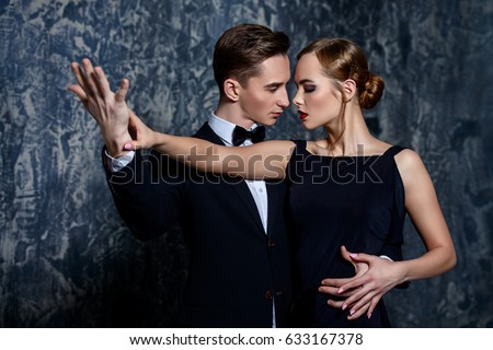 Beautiful passionate dancers dancing tango. Professional dancers. Couple in love dancing on a date. Love concept.