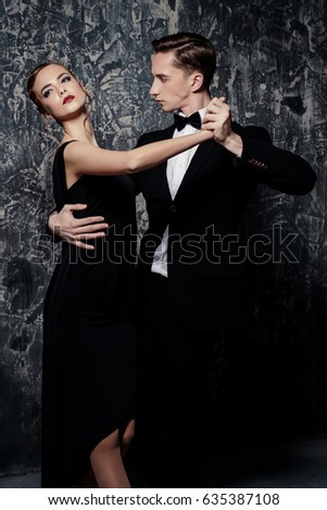 Beautiful passionate dancers dancing tango. Professional dancers. Couple in love dancing on a date. Love concept.