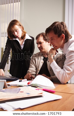 Group of 3 business people working together in the office.