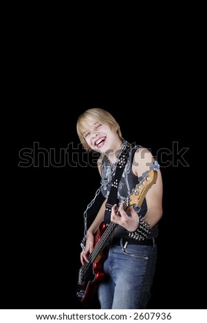 A young woman playing her guitar with expression.