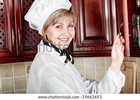 Cook woman cooking on the kitchen