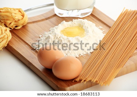 Baking ingredients, milk, and pastry isolated on white background