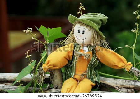 Gardening theme: rag doll on a garden fence.