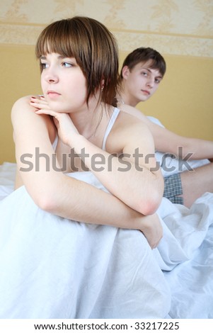 Young couple in a bedroom at home. Family conflict.