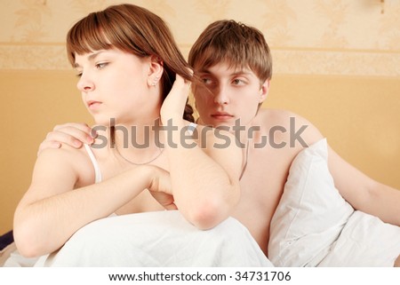Young couple in a bedroom at home. Family conflict.
