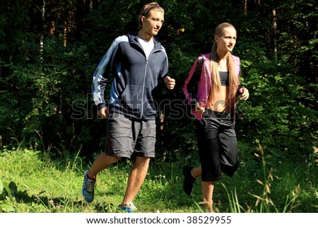Two young people running together in the morning.