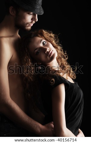 Portrait of a sexual couple. Shot in a studio.